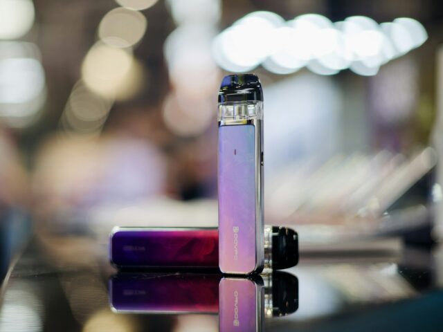 Two small devices on a table with bokeh lights