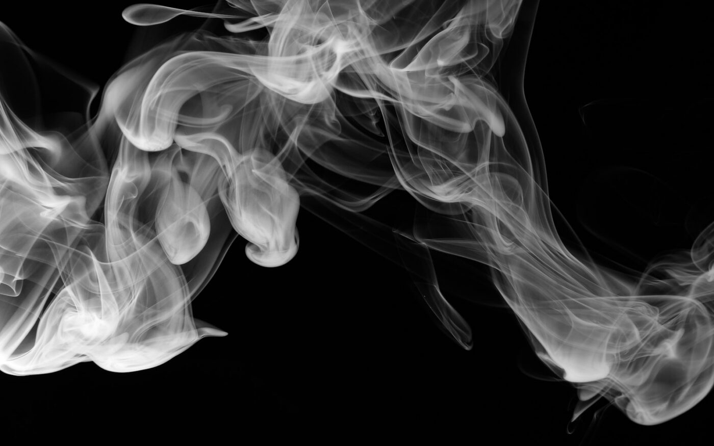 Wisps of white vapour on a dark background