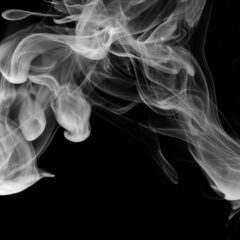 Wisps of white vapour on a dark background