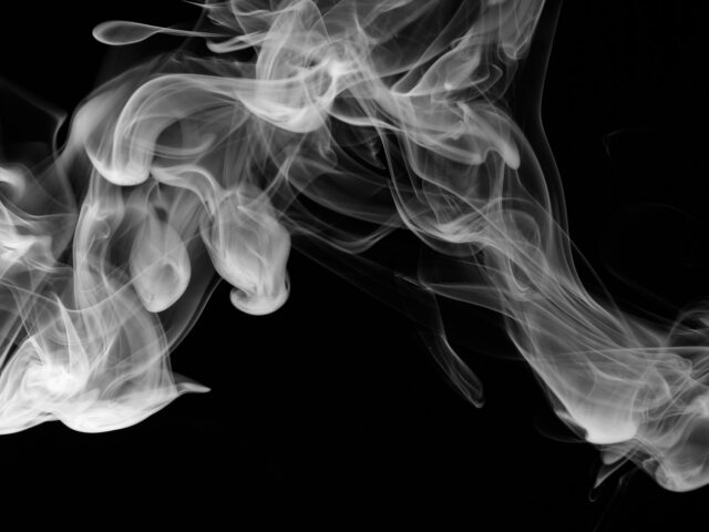 Wisps of white vapour on a dark background