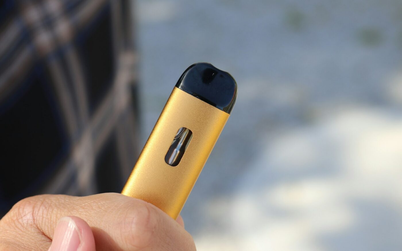 Hand holding a yellow pod device