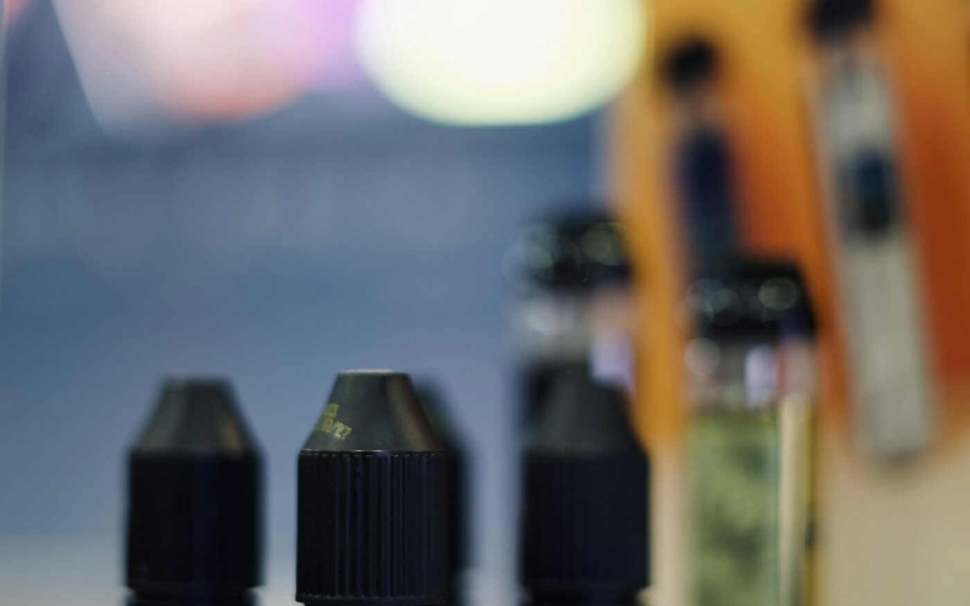 E-liquid bottles on a dark table