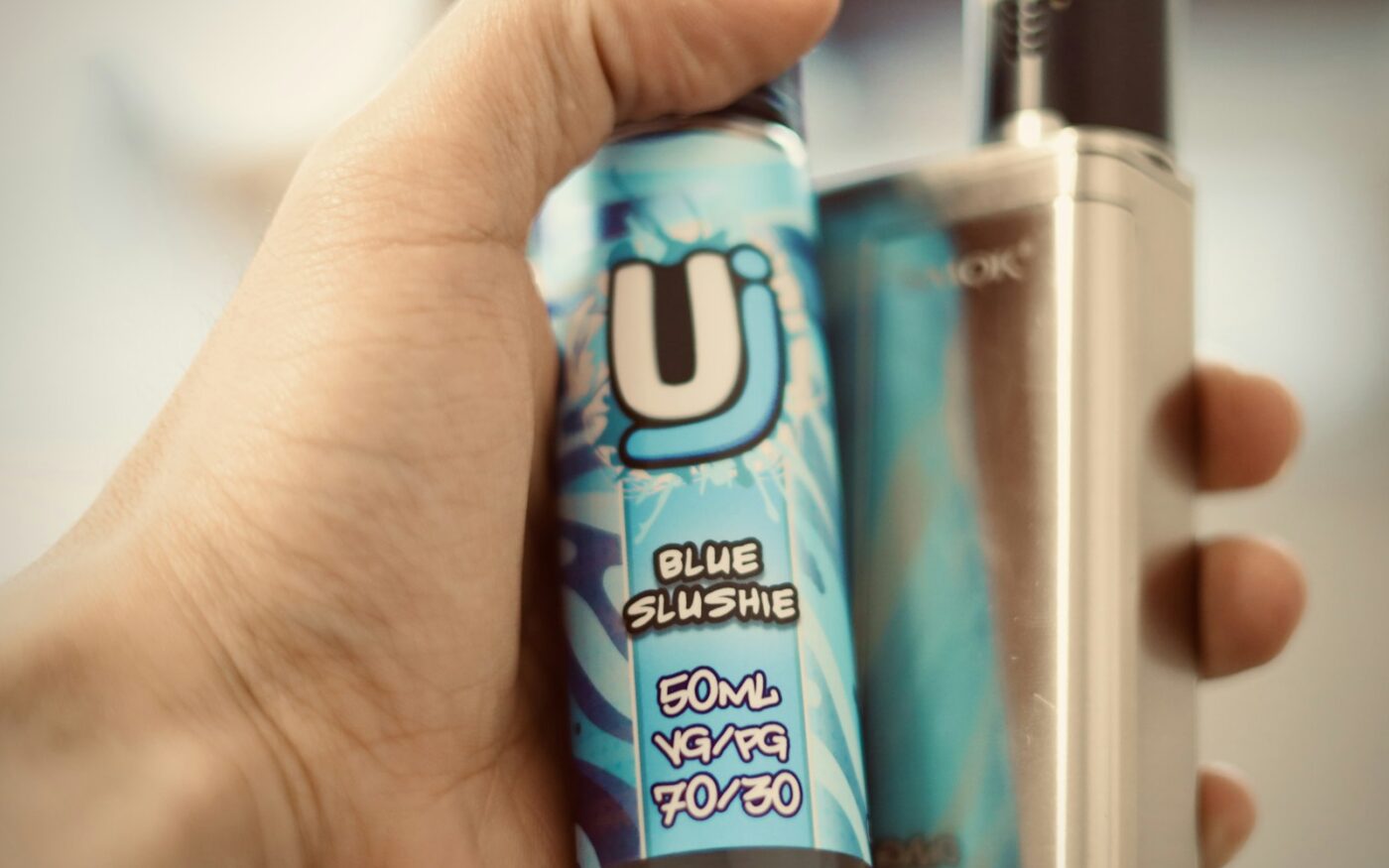 Hand holding a refillable pod
