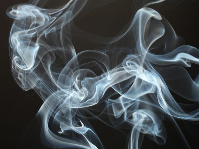 Vapour drifting across a black background