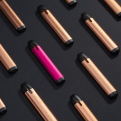 Rows of slim pod devices on a black surface