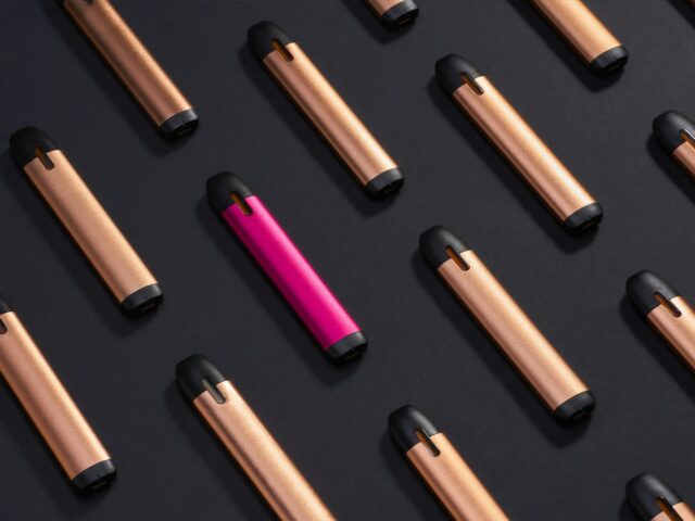 Rows of slim pod devices on a black surface
