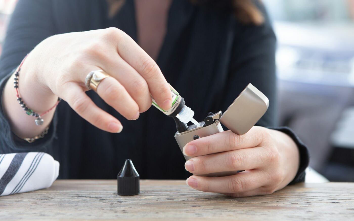 Hands holding a device over a table