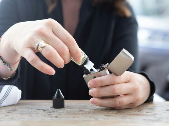 Hands holding a device over a table