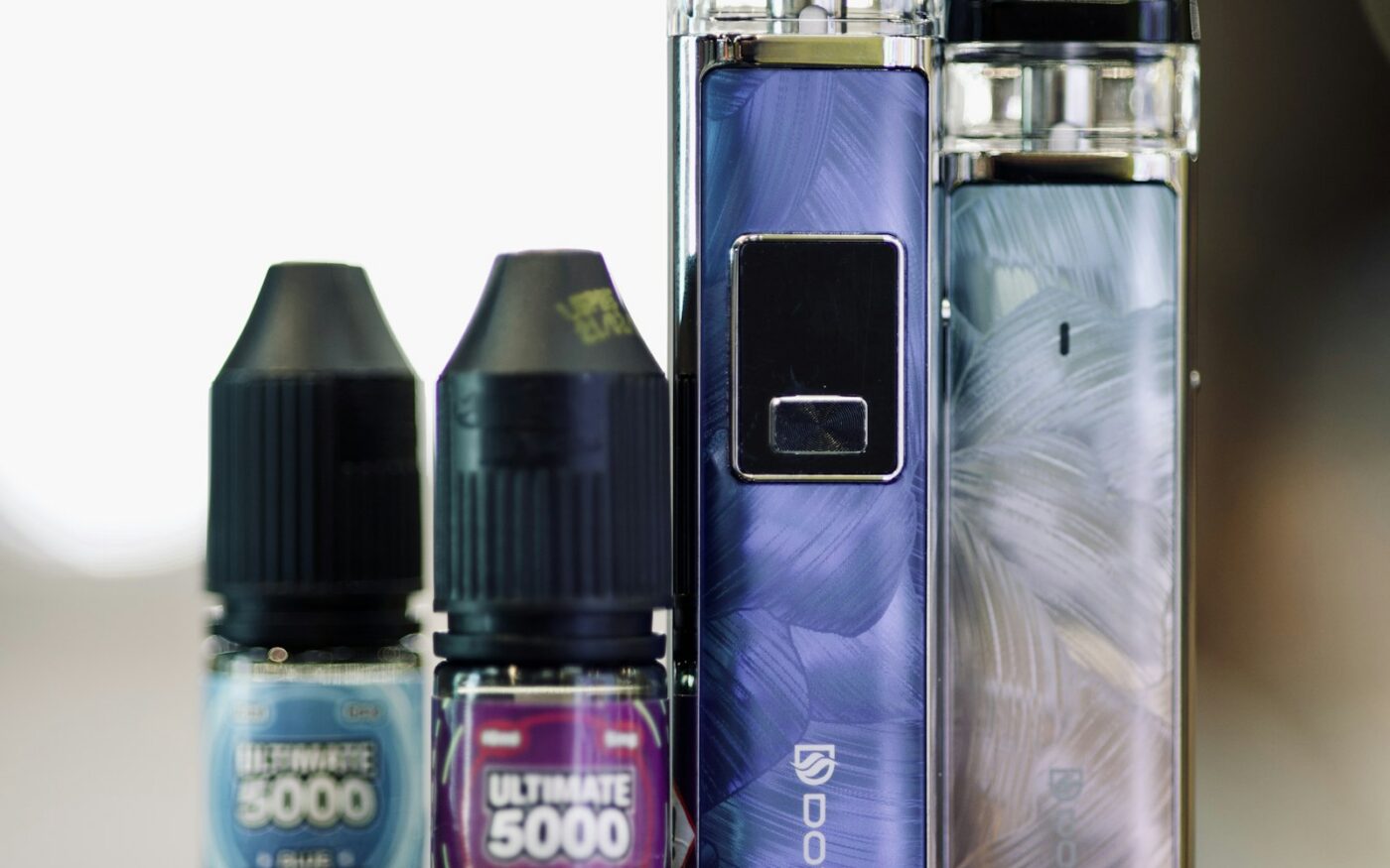 E-liquid bottles and devices on a table